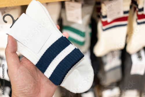 socks with blank tag. man choosing socks at the shop