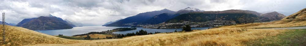 Panorama scenary of grass field on the mountain with lake view background at New Zealand. 