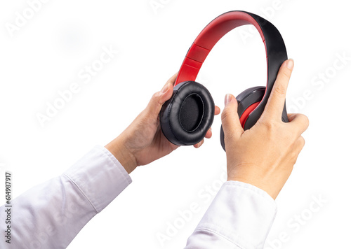 Close up Female Hand Holding headphone on white background, Red and black headphone on woman hand isolate on white with clipping path.