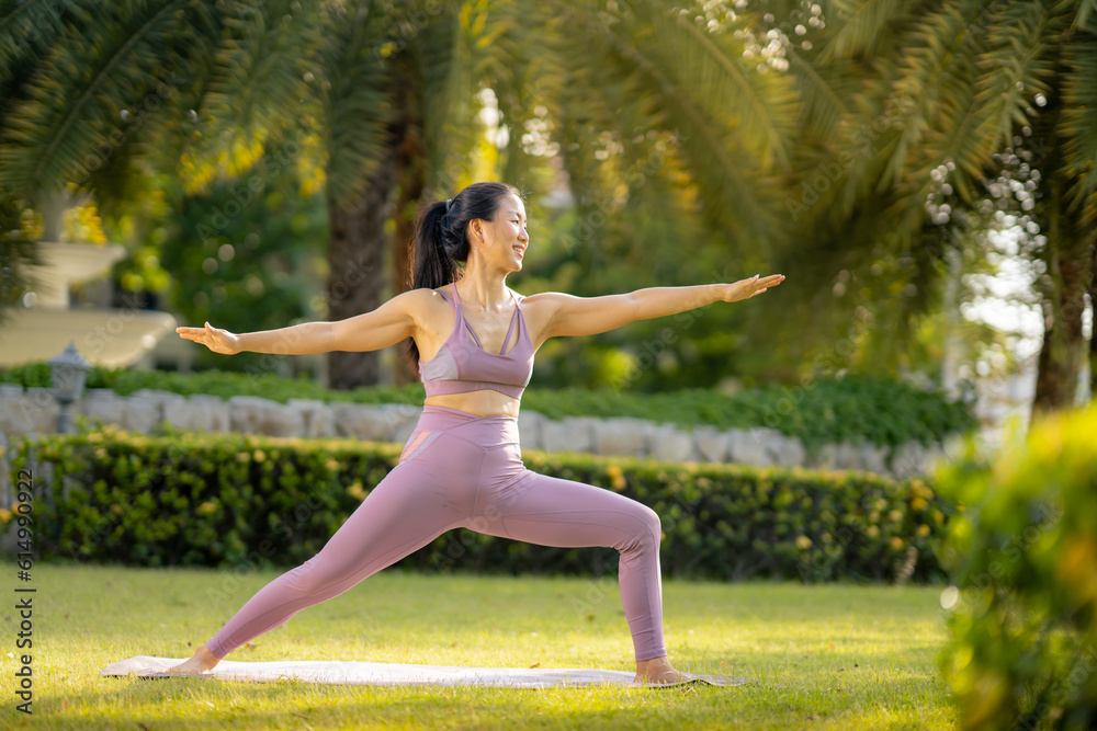Asian woman wearing yoga clothes doing yoga at her village garden in the morning, happily, Sports healthy lifestyle concepts, Japanese concepts. Asian woman wearing yoga clothes doing yoga at her village garden in the morning, happily, Sports healthy lifestyle concepts, Japanese concepts.