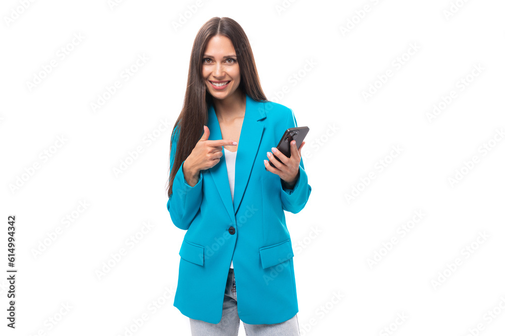 young confident attractive slim brunette model dressed in a stylish business jacket with a smartphone. office fashion concept young confident attractive slim brunette model dressed in a stylish business jacket with a smartphone. office fashion concept