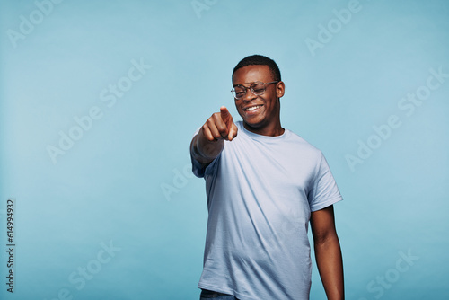 Smiling African man winking and pointing