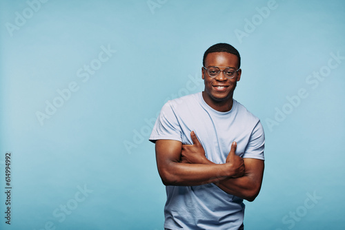 Smiling African man standing with arms crossed