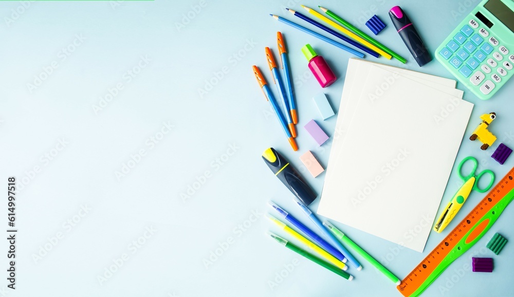 On a blue background, school supplies and office accessories, the concept of back to school, webinars, online learning, office work.  Flat lay, top view.  Copy space for text, space, banner.