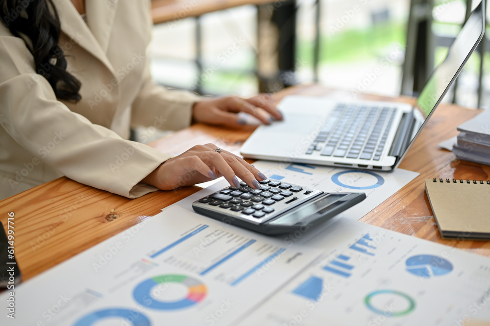 Close-up image of a professional businesswoman analyzing business financial data on reports Close-up image of a professional businesswoman analyzing business financial data on reports