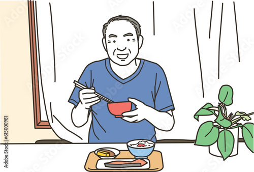 笑顔で食事をする高齢者のアジア人男性