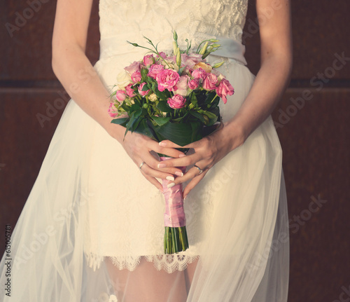 beautiful young bride with an incredible bouquet of wedding flowers in her hands