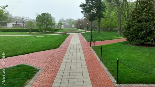 Wallpaper Mural First person aerial shot of brick sidewalks on foggy college campus. Green lawns and historic academic buildings surround green landscaping on walkable University of Delaware campus. Torontodigital.ca