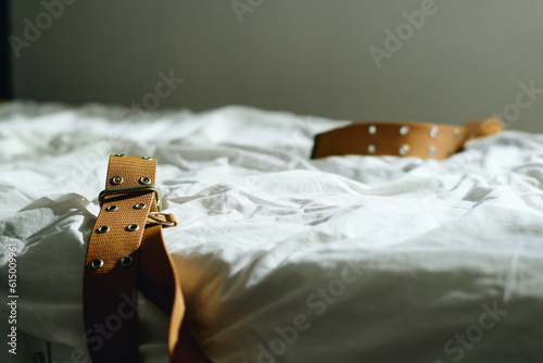 Part of bed in ward of mental hospital with tight brown belts prepared for insane patients supported by professional psychiatrists of clinics