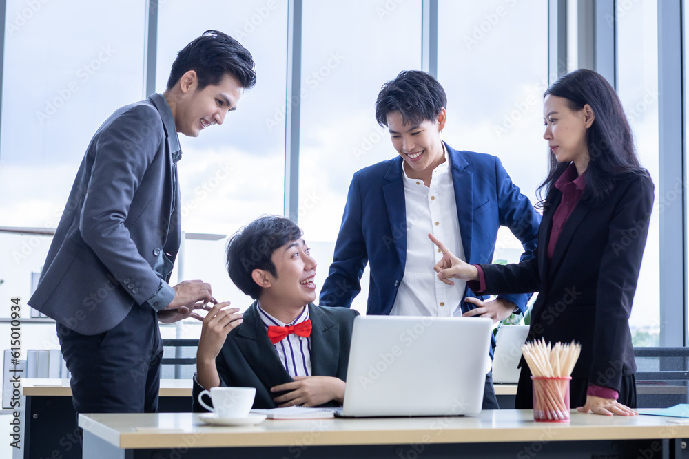 Successful happy workers Group of asian business people with diverse genders (LGBT) and congratulate to Homosexual businessman see a successful business plan on the laptop computer at office