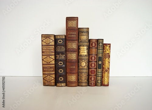 Antique leather books with gold decorations.