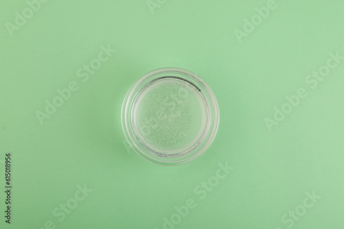 Water soluble Xanthan gum in bowl. Food additive E415. Used in food industry, medicine, cosmetics, beauty products, hair products as binding agent. Texture improver. Stabiliser and Thickener photo