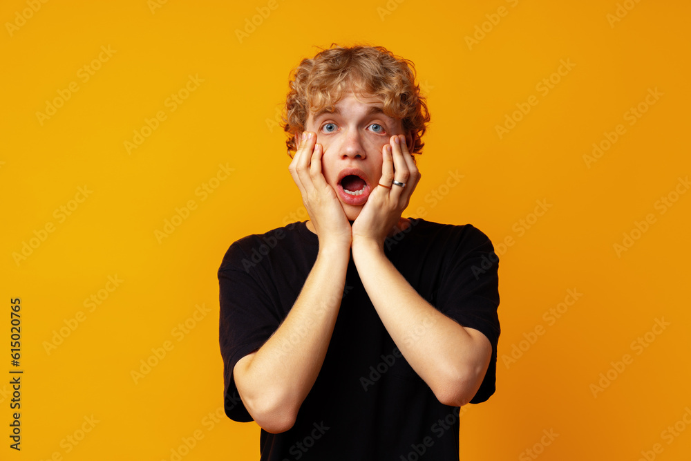 Young man over yellow background with surprise facial expression Young man over yellow background with surprise facial expression