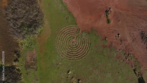 Concentric circle stone pattern on binimel-la beach menorca spain in red dirt earth photo