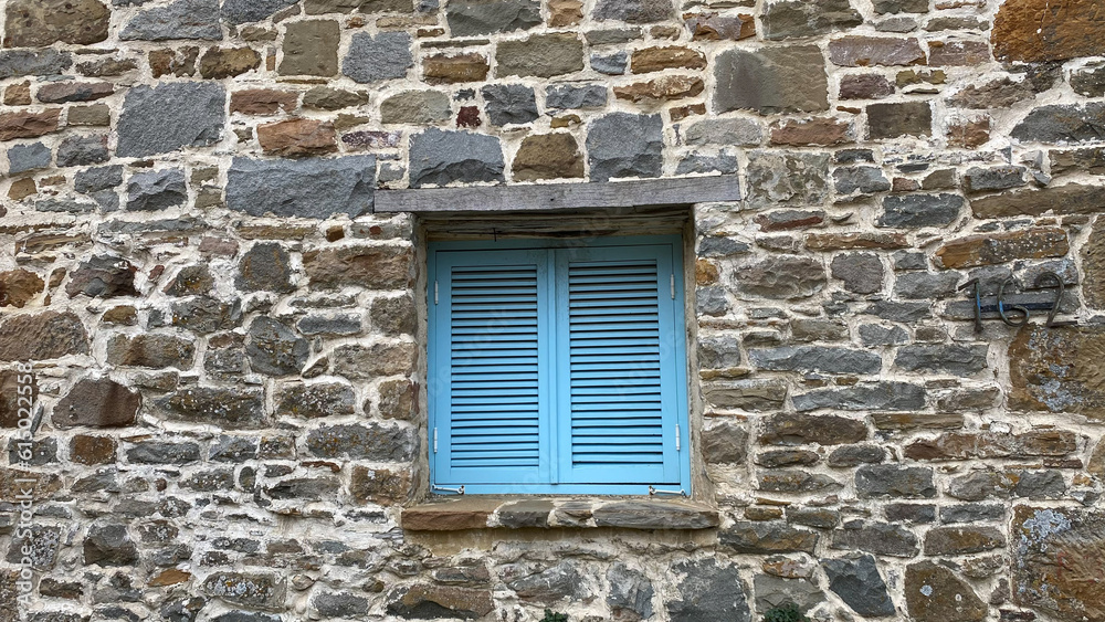 Traditional Greece, Mediterranean, Aegean type stone house window with blue blinds