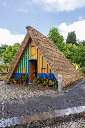 Blue and yellow Santana style house with high thatch roofs