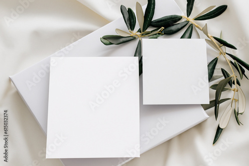 Delicately white silk background, white A4, A6 paper cards, business cards and flyers for a cosmetic company, beauty industry. Soft background, gentle colors. Generative AI
