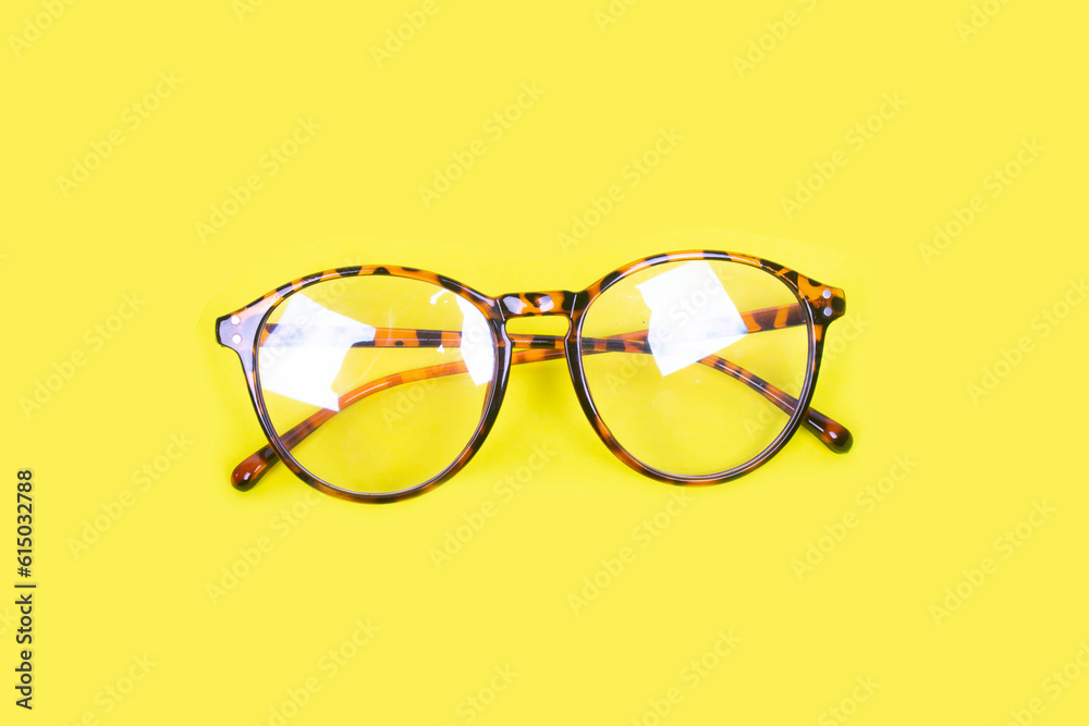 photo of glasses on yellow paper photo of glasses on yellow paper