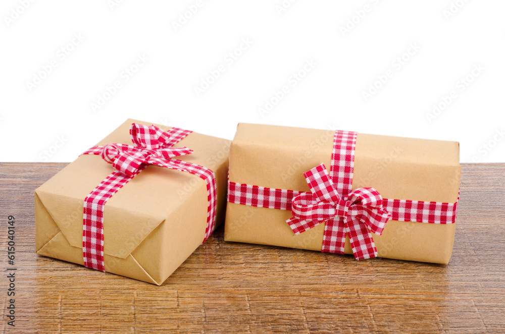 Gift boxes with red checkered ribbon on wooden background Gift boxes with red checkered ribbon on wooden background