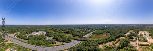 180 panorama with wildlife crossing green corridor bridge for animals to migrate between conservancy areas over Dutch interstate highway. Engineering aerial environment nature reserve infrastructure