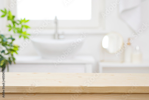 Blurred bathroom hand washing corner with wooden table in front