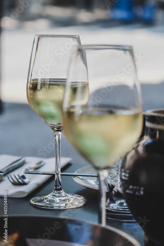 Two glasses of white wine, partially out of focus