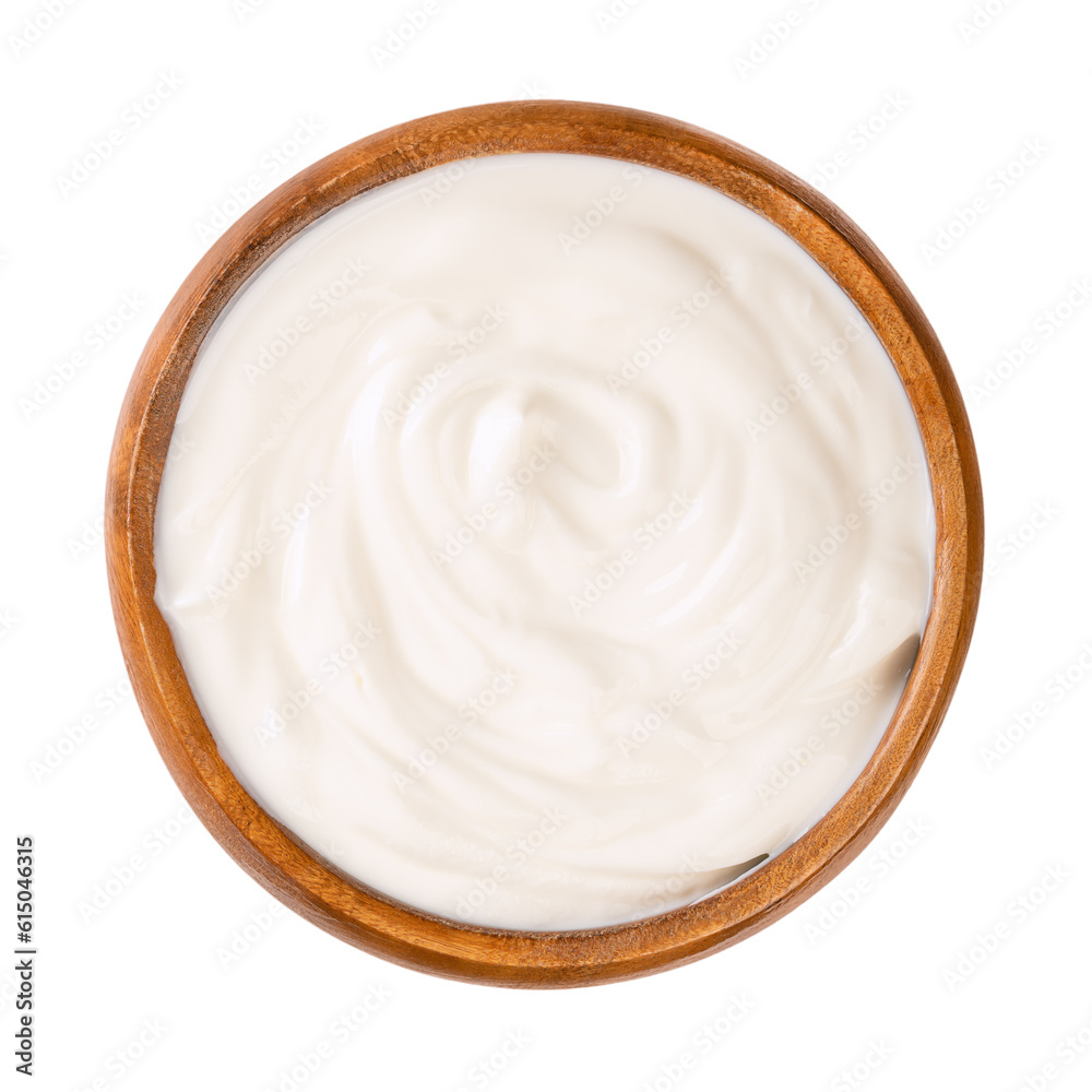 Cream yogurt, in a wooden bowl. Stirred yoghurt, also spelled yogourt or yoghourt, with ten percent fat content. Dairy product, made by bacterial fermentation of mostly cow milk with yogurt cultures. Cream yogurt, in a wooden bowl. Stirred yoghurt, also spelled yogourt or yoghourt, with ten percent fat content. Dairy product, made by bacterial fermentation of mostly cow milk with yogurt cultures.