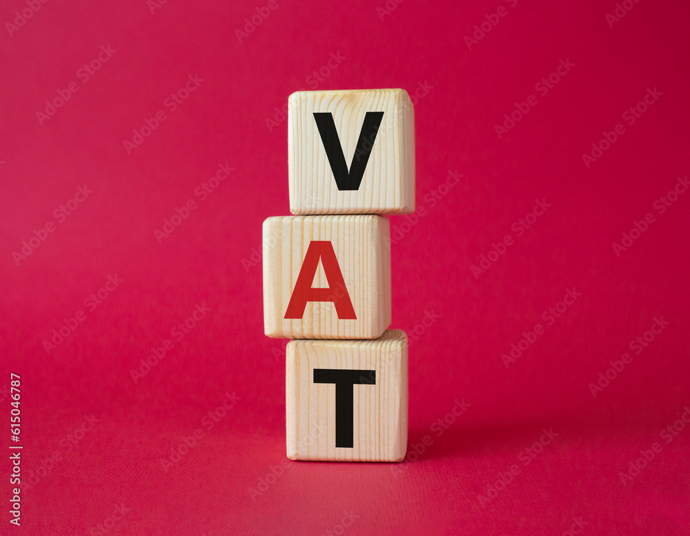 VAT - Value Added Tax symbol. Wooden cubes with word VAT. Beautiful red background. Business and Value Added Tax concept. Copy space. VAT - Value Added Tax symbol. Wooden cubes with word VAT. Beautiful red background. Business and Value Added Tax concept. Copy space.