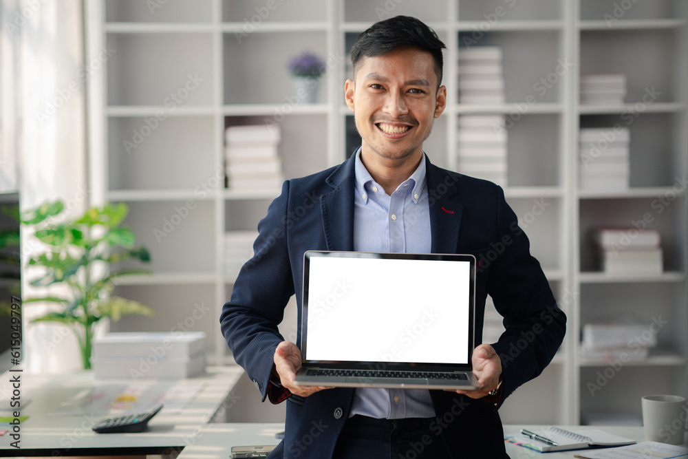 Man holding laptop with blank screen, he is young energetic businessman, modern business management, start-up company run by young people, modern entrepreneur with fresh ideas. to be a business leader Man holding laptop with blank screen, he is young energetic businessman, modern business management, start-up company run by young people, modern entrepreneur with fresh ideas. to be a business leader