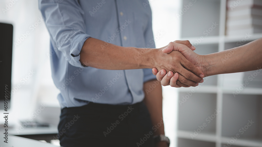 Fototapeta premium Business investor group holding hands, Two businessmen are agreeing on business together and shaking hands after a successful negotiation. Handshaking is a Western greeting or congratulation.