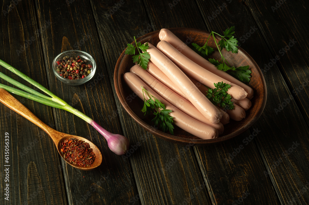 Sausages are semi-finished products for fast food from pork, beef or chicken, ready to eat in a plate. Fast food concept with spices and onions Sausages are semi-finished products for fast food from pork, beef or chicken, ready to eat in a plate. Fast food concept with spices and onions
