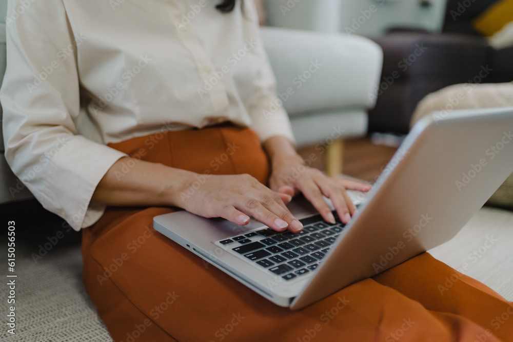 Working by using a laptop computer on wooden table. Hands typing on a keyboard.technology e-commerce concept Working by using a laptop computer on wooden table. Hands typing on a keyboard.technology e-commerce concept