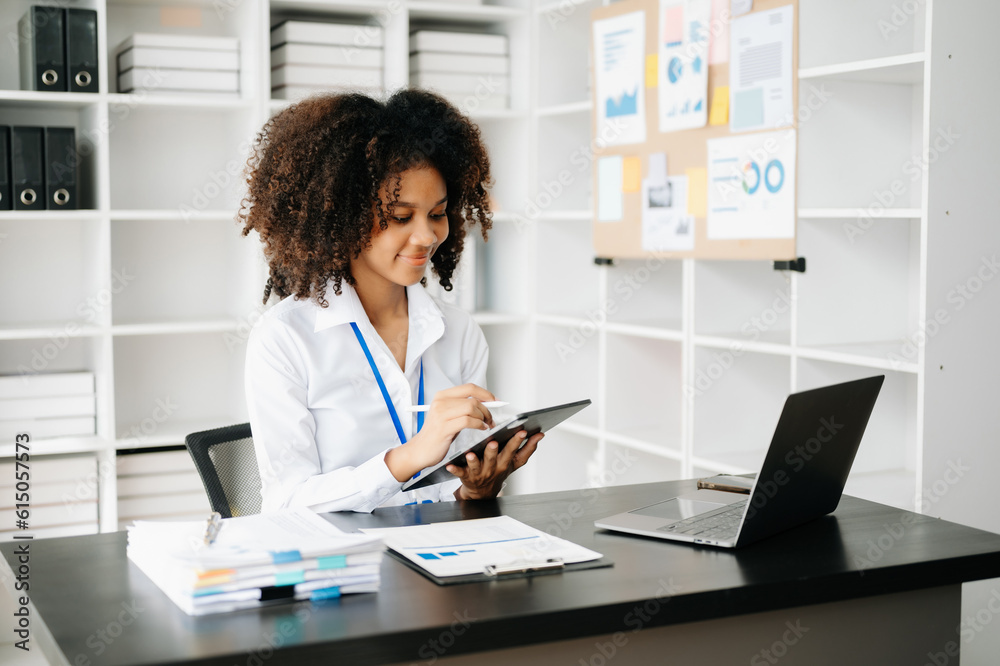 Business woman using tablet and laptop for doing math finance on an office desk, tax, report, accounting, statistics, and analytical research concept in office