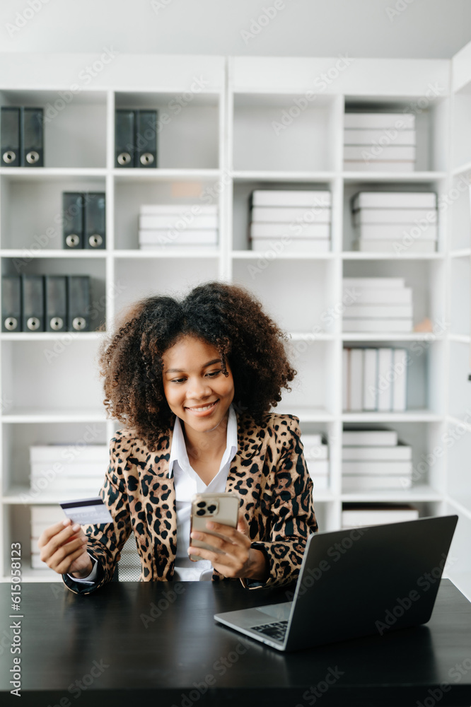African Woman using smart phone for mobile payments online shopping,omni channel,sitting on table,virtual icons graphics interface screen African Woman using smart phone for mobile payments online shopping,omni channel,sitting on table,virtual icons graphics interface screen