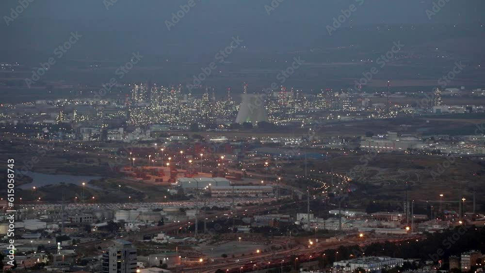 Beautiful evening view of the city of Haifa from the mountain. Large Israeli port. Street lights illuminate the streets and the city. Beautiful evening view of the city of Haifa from the mountain. Large Israeli port. Street lights illuminate the streets and the city.