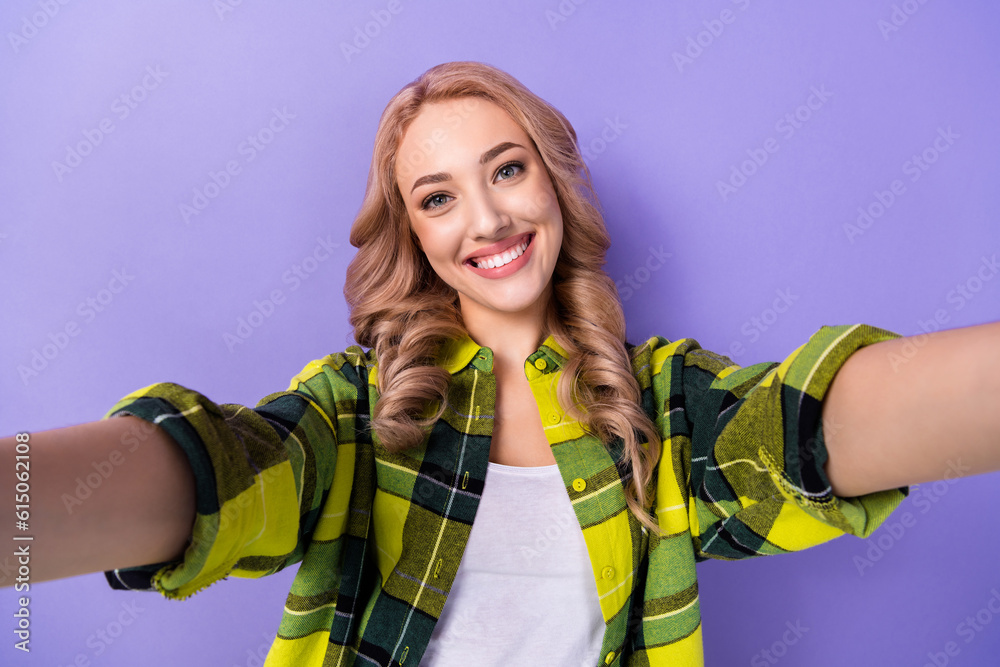 Photo of cheerful sweet lady wear plaid yellow shirt tacking selfie smiling isolated violet color background Photo of cheerful sweet lady wear plaid yellow shirt tacking selfie smiling isolated violet color background