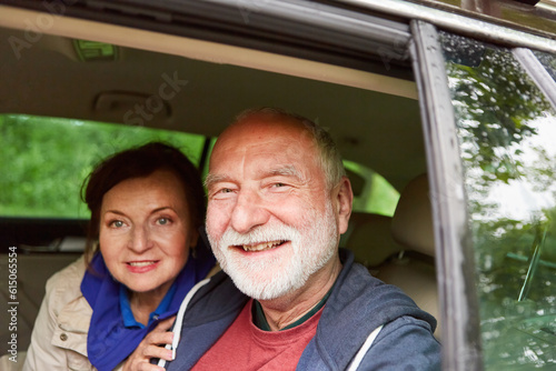 Happy senior couple seen through window during road trip
