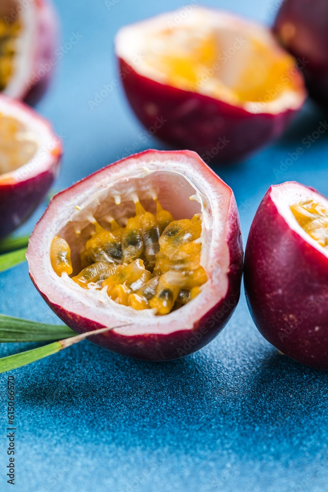 Ripe passion fruit, half and slice of fruit on a blue background. Ripe passion fruit, half and slice of fruit on a blue background.
