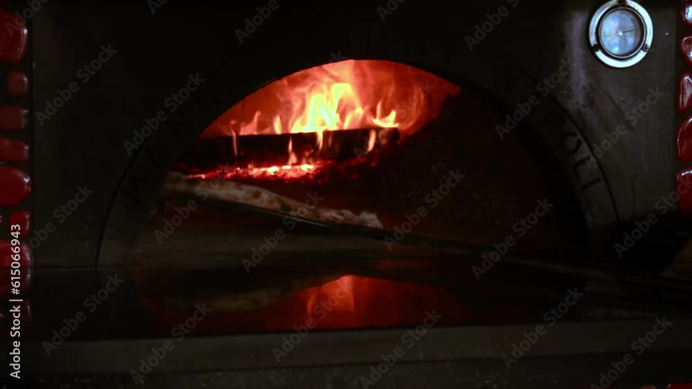 Baking round pasty pizza in the hot oven at the restaurant, spinning