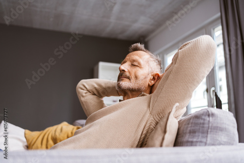 Fotografia Older Man Leaning Relaxingly on His Sofa with Closed Eyes, Gazing Upwards