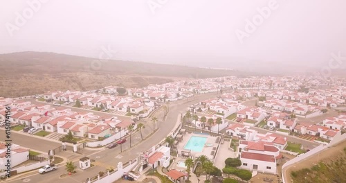 View from a drone flying over rosarito condominiums during a cloudy day in Baja California, Mexico photo