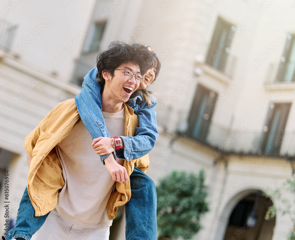 Fototapeta premium woman couple man happy hugging love young together piggyback travel tourist romantic hugging outside city vacation student smile fun relationship joy bonding