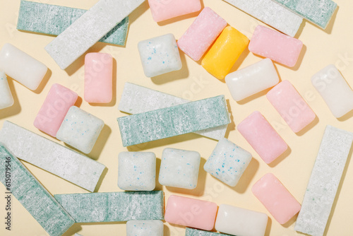 Fotografie Various types of mint and fruit gum on a yellow background top view