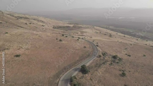 Cars drive along a winding mountain road