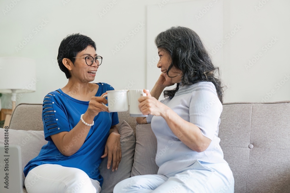Elderly women drinking coffee while sitting on sofa at home Elderly women drinking coffee while sitting on sofa at home
