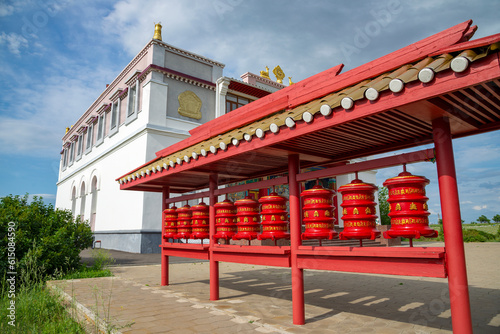 Buddhist prayer drums on the background of the Shakyusn-Syume Temple. The neighborhood of Elista. Kalmykia photo