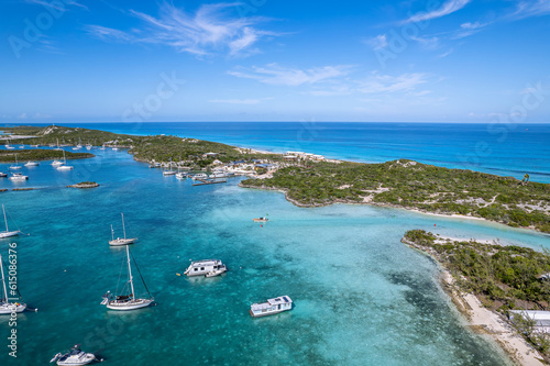 Drone aerial view of anchored sailing yacht in emerald Caribbean Sea, Stocking Island, Great Exuma, Bahamas. photo