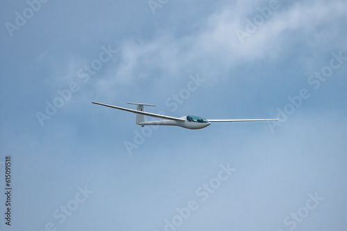 Glider plane flying in the clouds