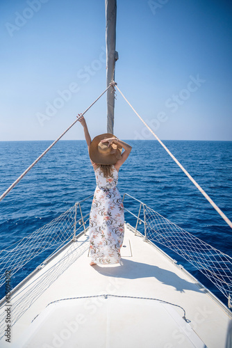 Young woman sailing, young adult lady enjoying summer travel, close-up portrait of female face, summer cruise holidays, European girl tourist traveling in sail boat 