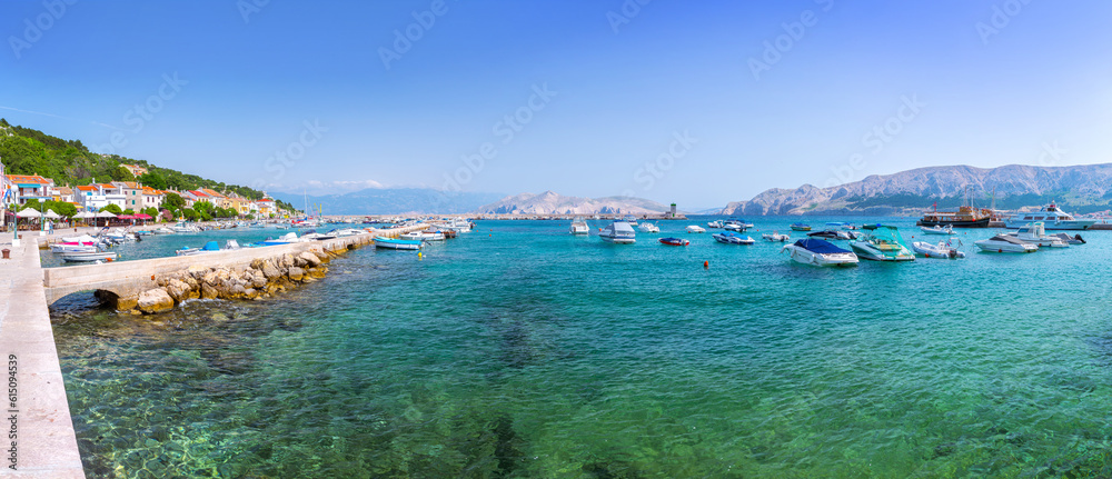 Baska. Krk island. Croatia - JUNE 22, 2016: Wonderful summer panoramіс landscape coastline Adriatic sea. Boats and yachts in crystal clear turquoise water. Harbor in old city.